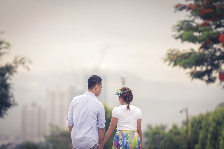 A man and a woman hold hands while walking