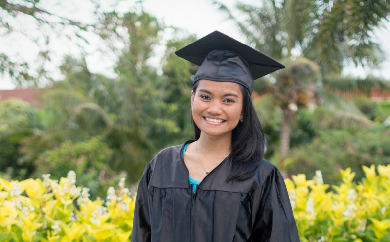 A woman wearing a graduation cap and gown