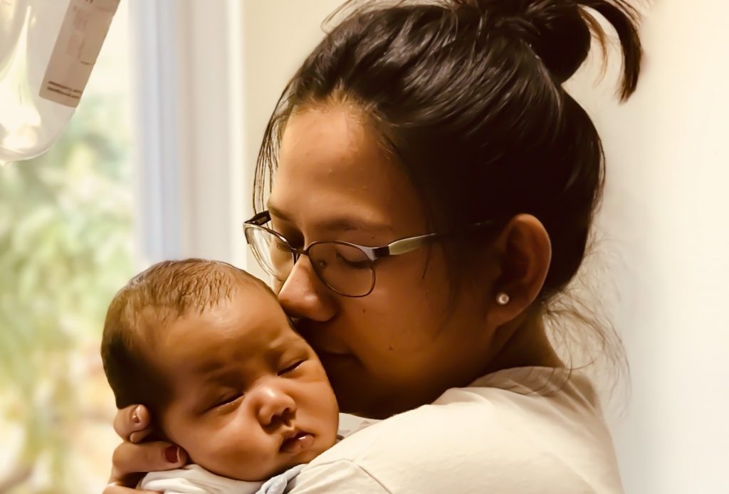 young mother kissing baby