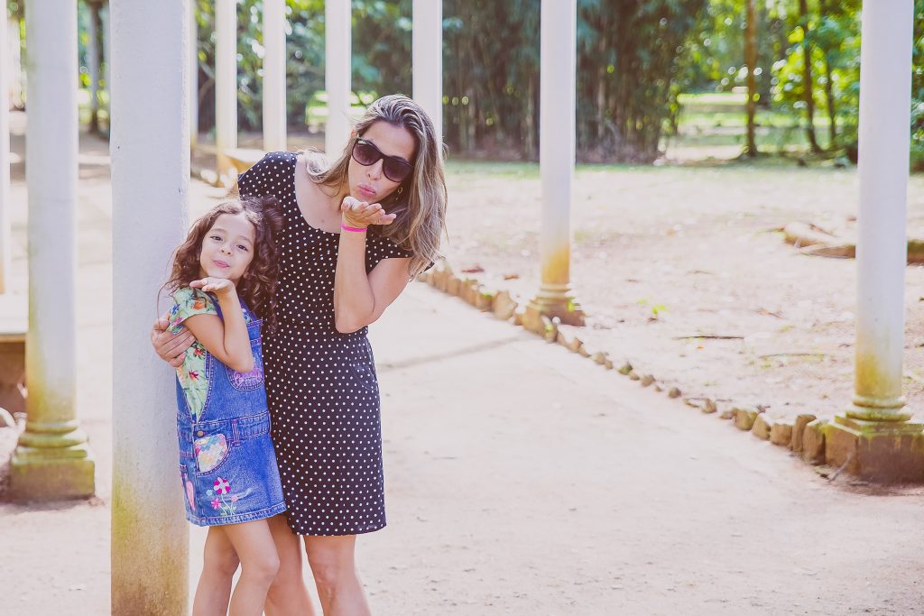 mother and daughter blowing kisses
