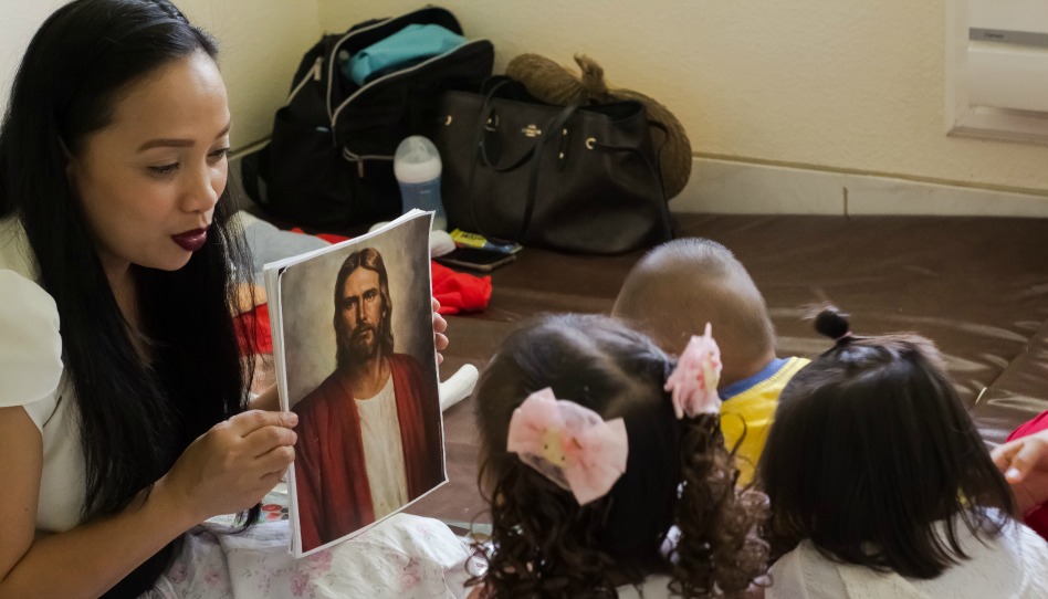 A mom teaching her kids about Jesus.