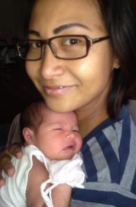 baby held close to a mother's chest