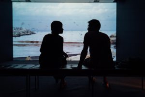 man and woman sitting facing each other