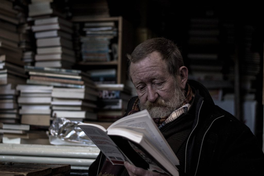 man in library reading