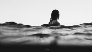 A girl drifting with the waves of the sea.